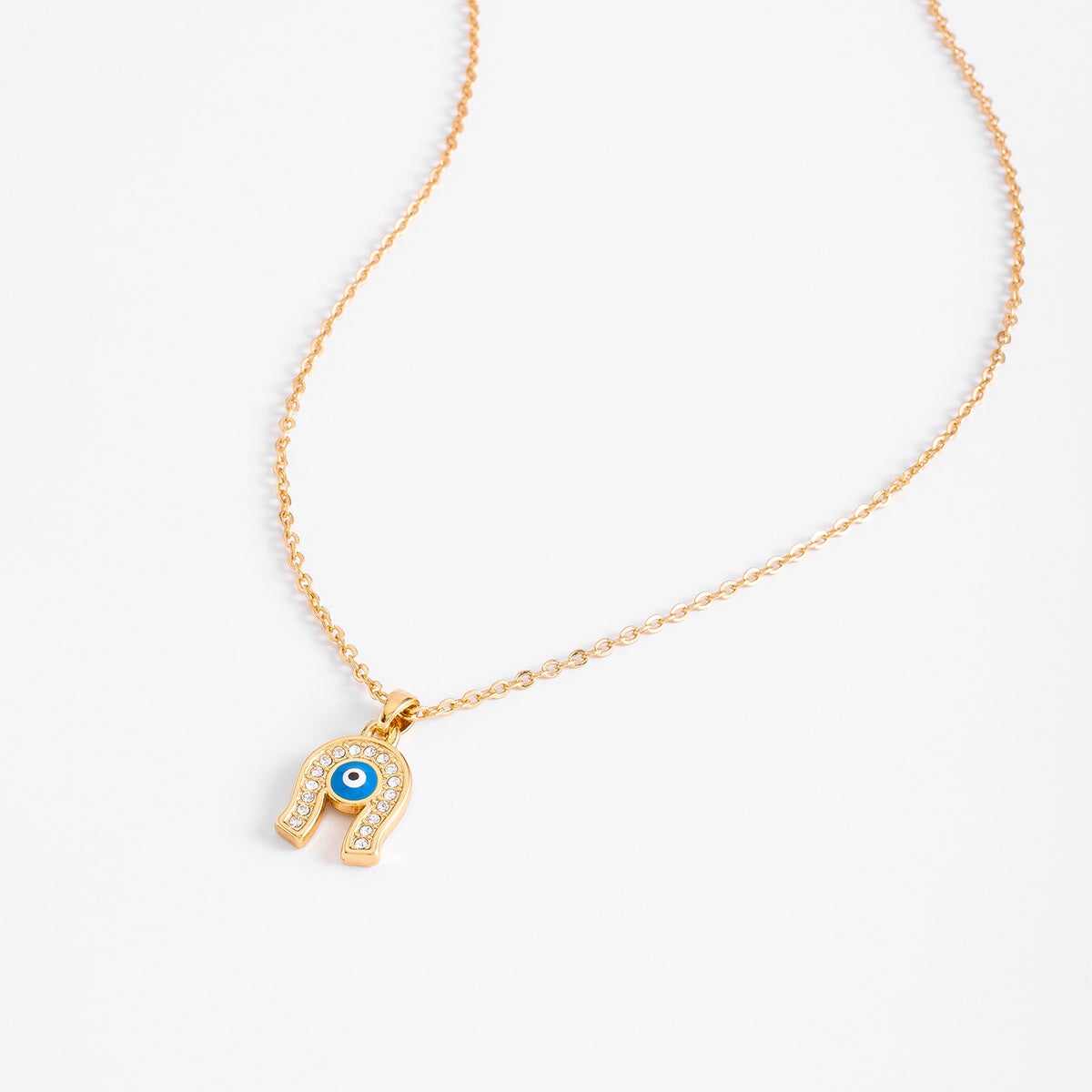 Gold plated charm necklace with blue enamel and crystal tone stones
