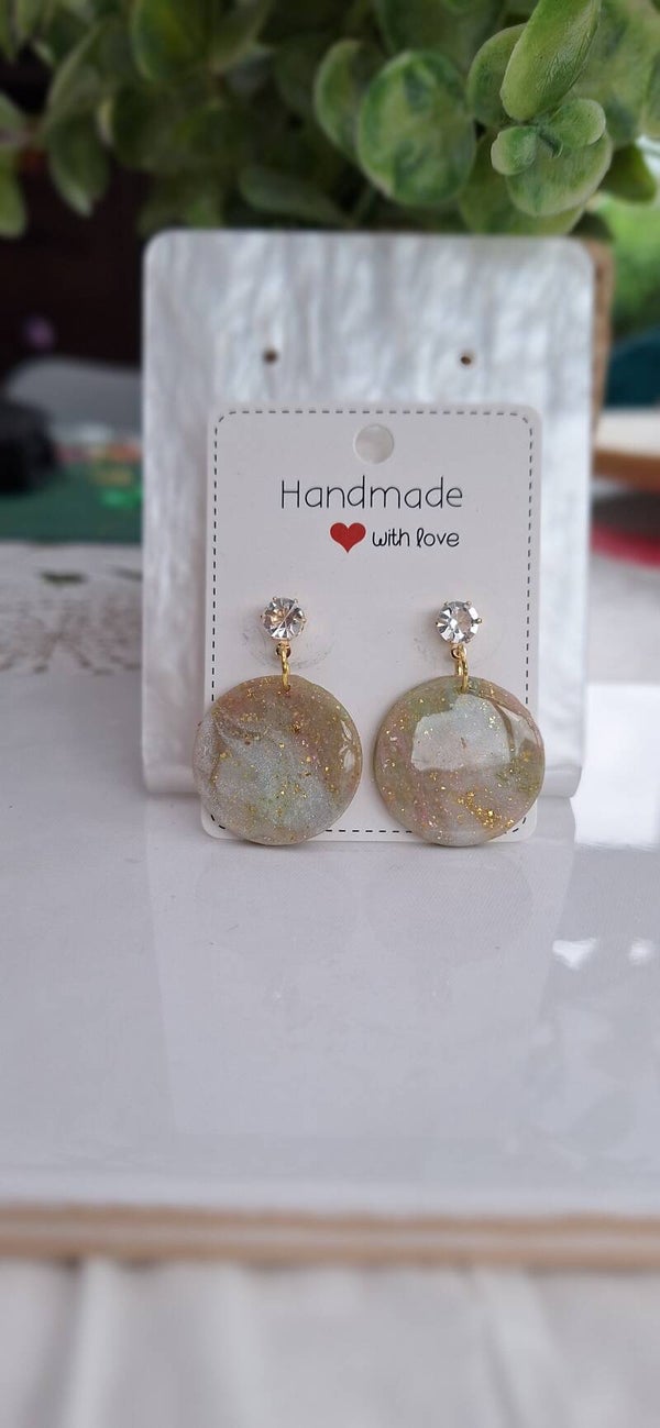 Ronde oorbellen in marmereffect met gouden accent.