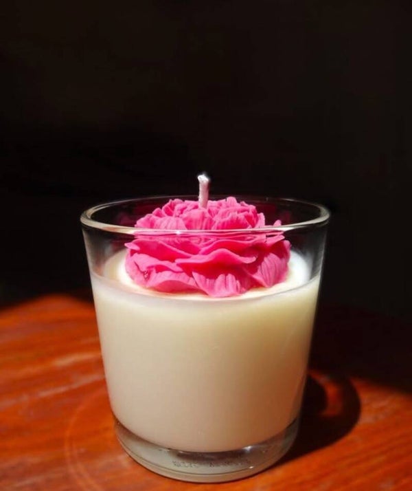 candles and flower in a jar