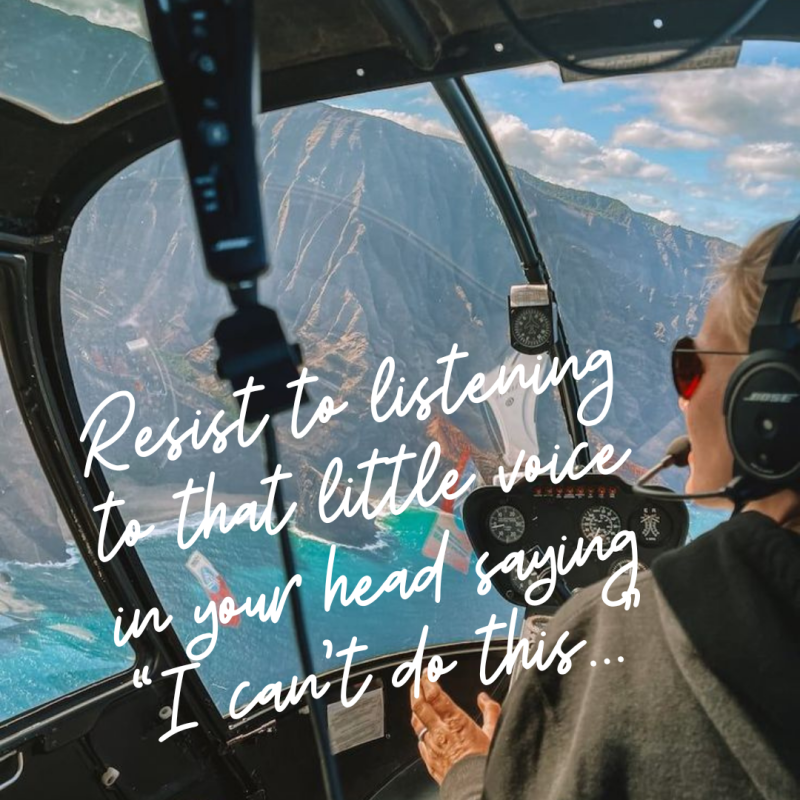 Blond woman wearing sunglasses flying in a helicopter over mountains. Resist2it.com