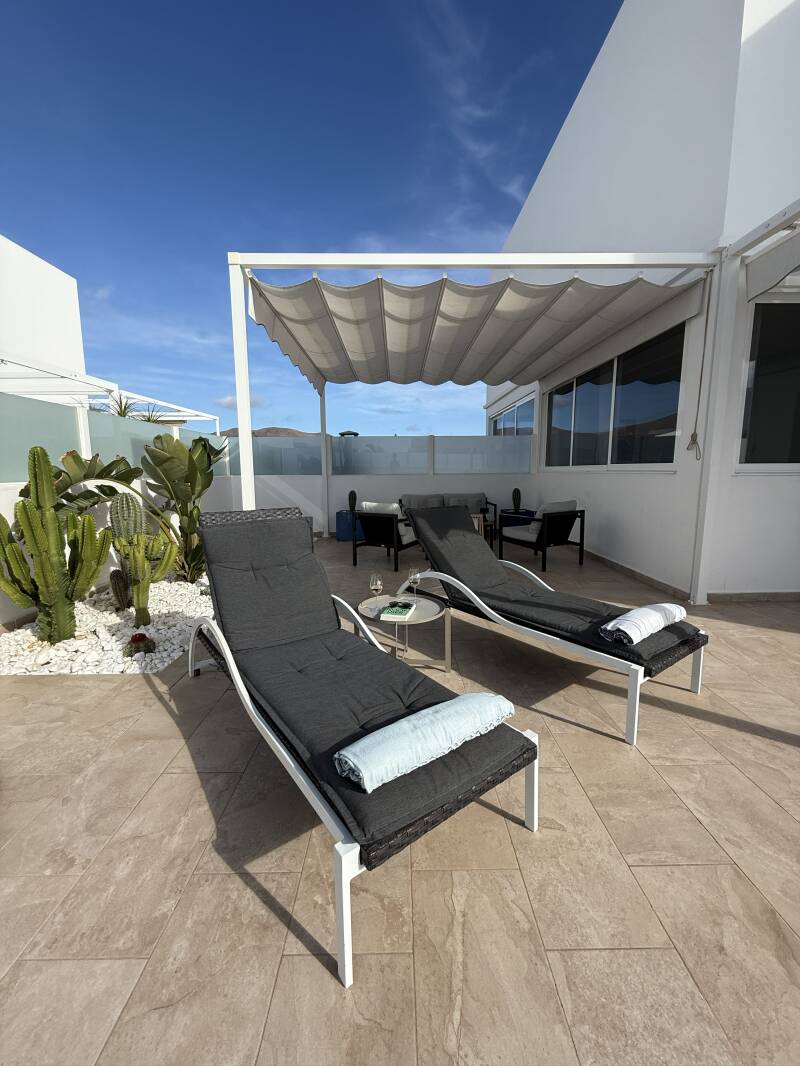 Sun loungers beside the private swimming pool at Casa Havn