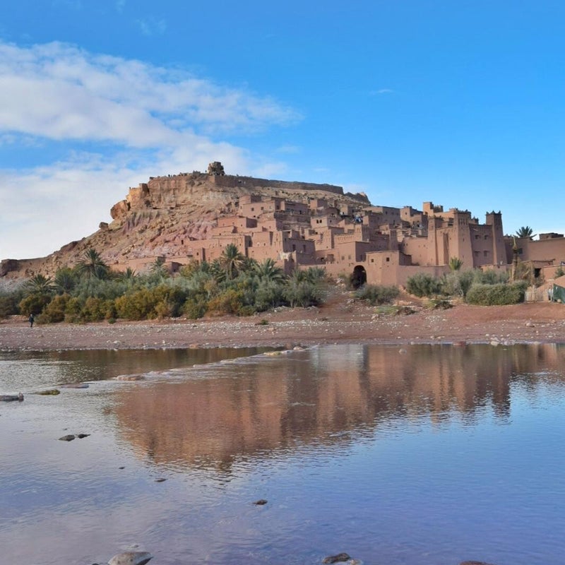 Historic Aït Ben Haddou kasbah, a UNESCO World Heritage site in Morocco, featuring traditional earthen architecture against a dramatic desert backdrop.