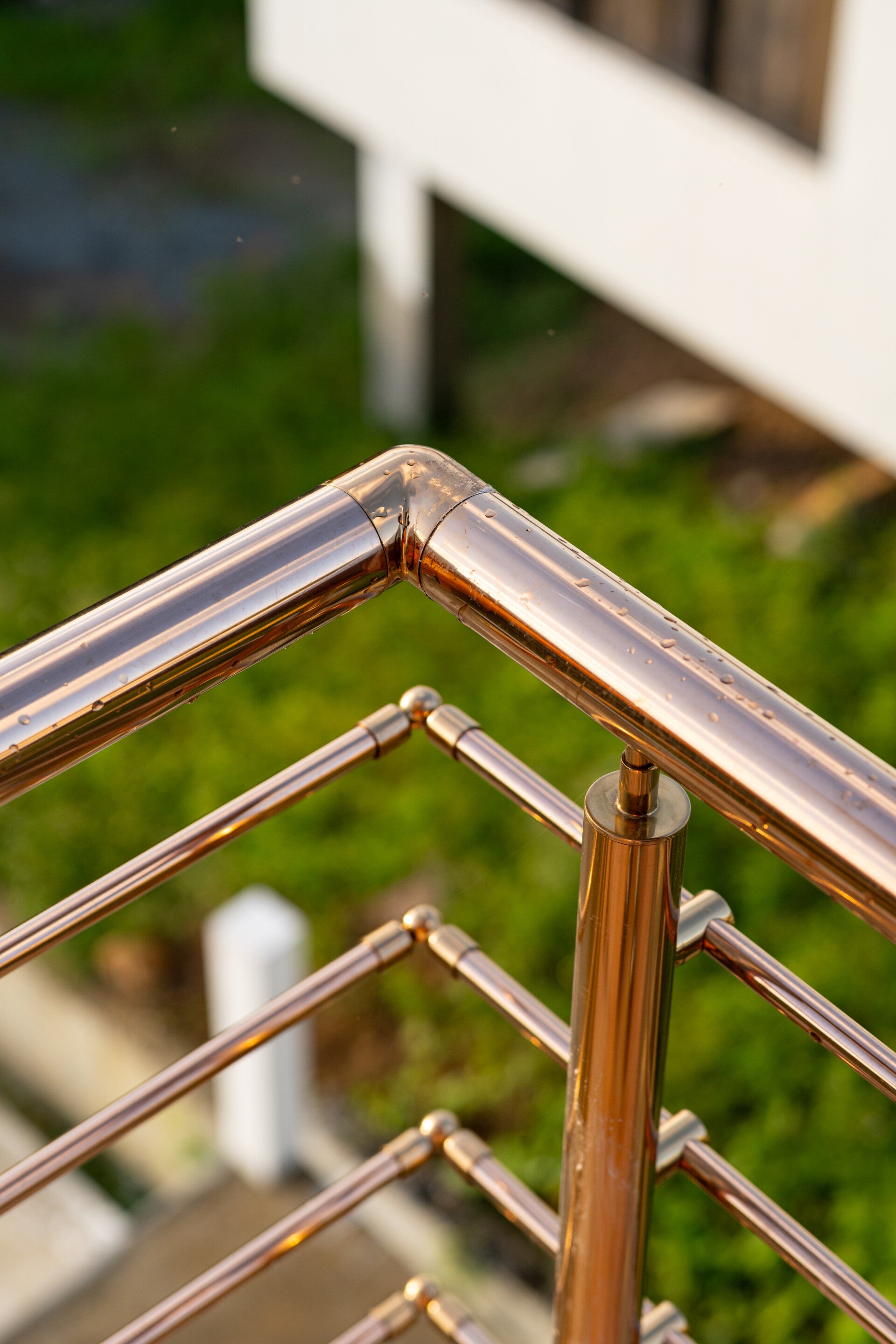 Close-up of stainless steel cross-bar railing joint and weld finish.
