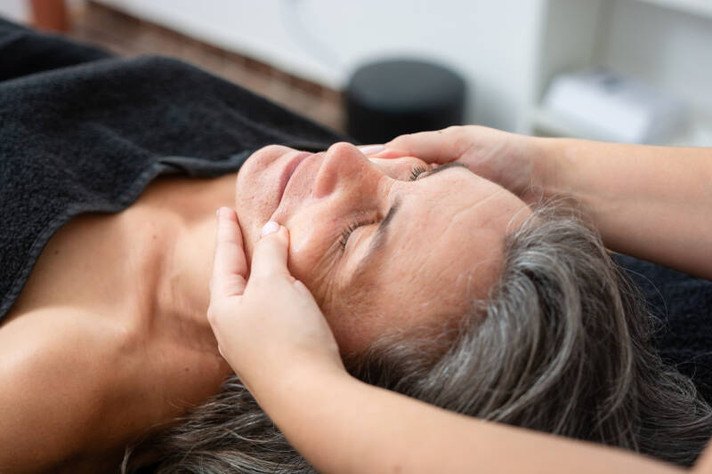 massage du visage sur une personne âgée