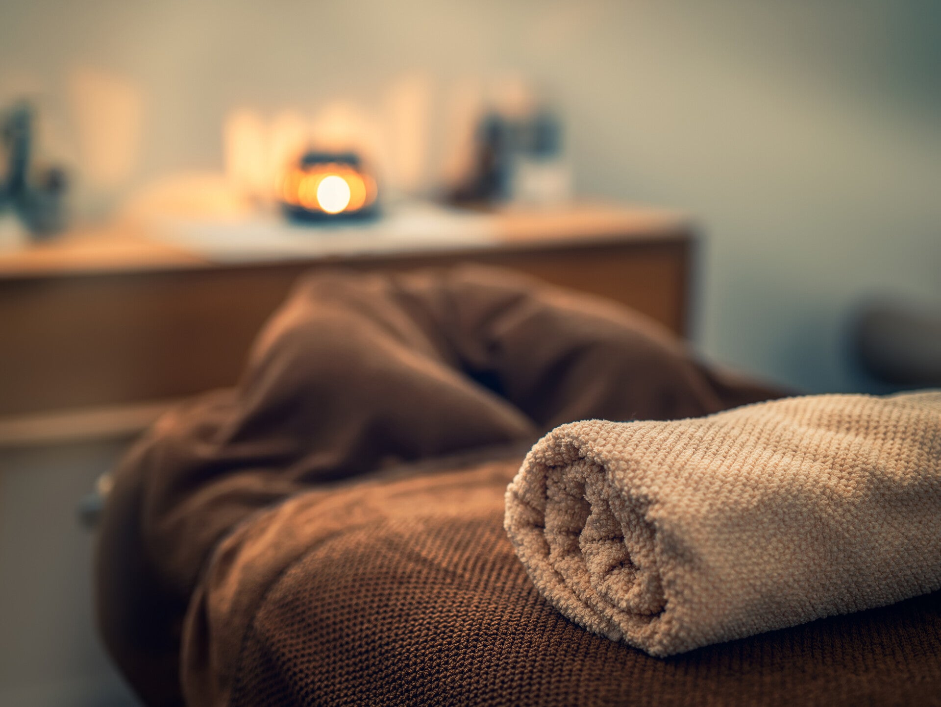 espace de massage chaleureux avec serviettes, invitant à la détente et au relâchement