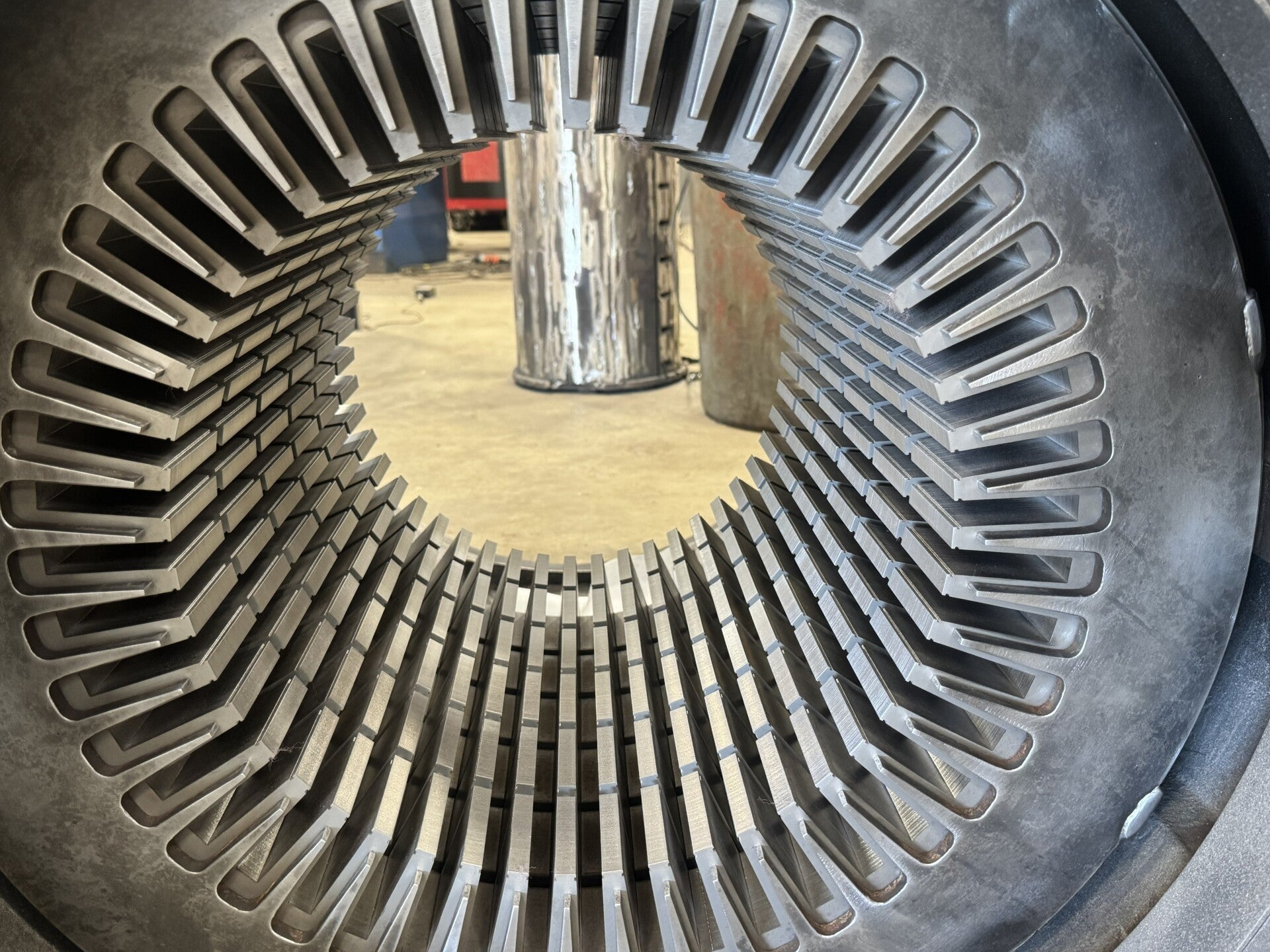 "Detailed view of a large stator, showcasing its substantial size and intricate winding patterns for industrial applications