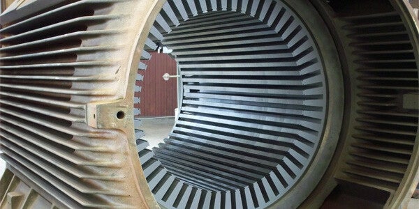 "Close-up view of an AC/DC motor, showing detailed components such as the rotor, stator, and wiring connections for dual power compatibility.