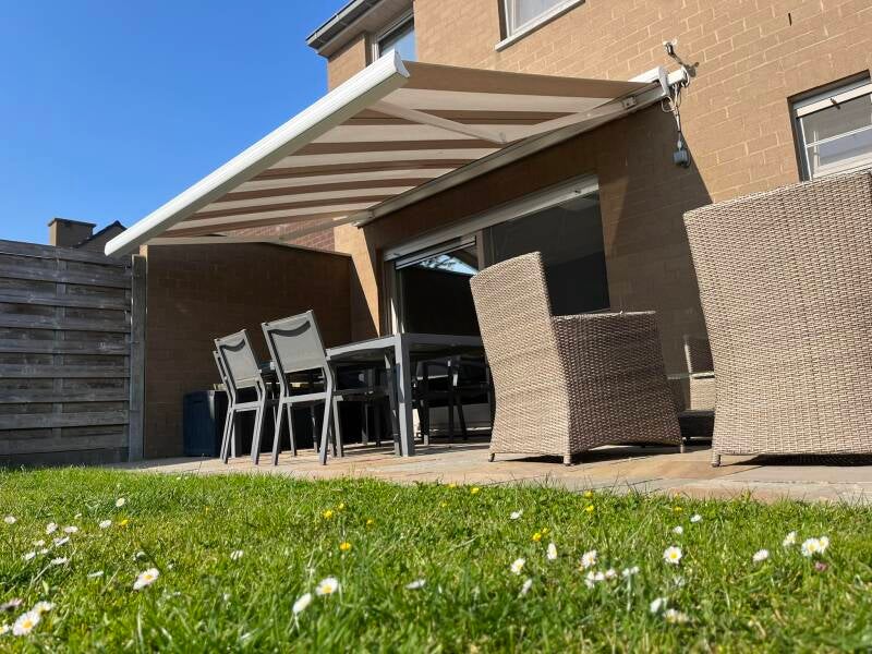 Herstelling gescheurd doek van terrasscherm in Ieper door firma Neyrinck uit Wervik 