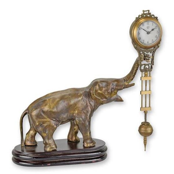 CL-118 A TABLE CLOCK MYSTERIEUSE HELT BY AN ELEPHANT