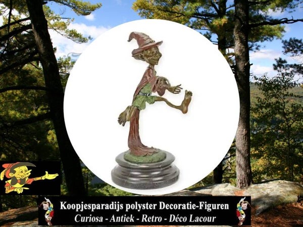 A BRONZE SCULPTURE OF A GOBLIN