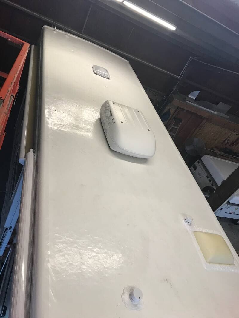 Applying protective rubber roof coating to RV for UV protection and leak prevention – mobile service