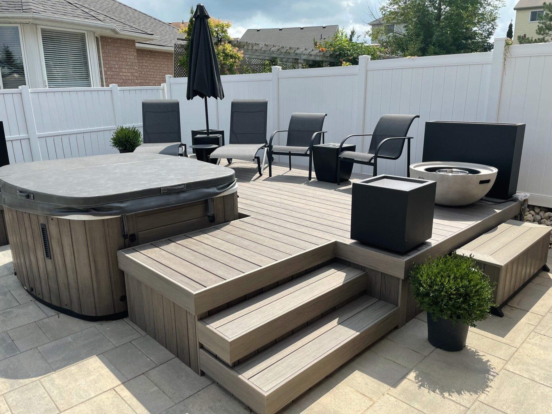 hot tub with attached deck and seating