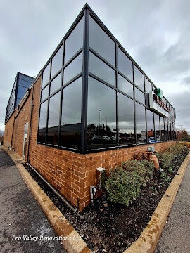 Commercial building exterior window cleaning for large glass panels by Pro Valley Renovations LLC.
