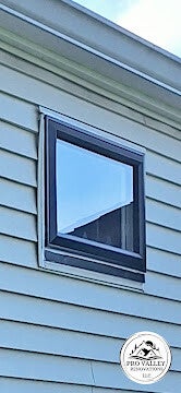 Vinyl replacement window installation on residential siding by Pro Valley Renovations LLC.