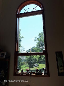 Interior tall arched window cleaning improving natural light by Pro Valley Renovations LLC.tial arched window cleaning service for clear, streak-free finish by Pro Valley Renovations LLC.