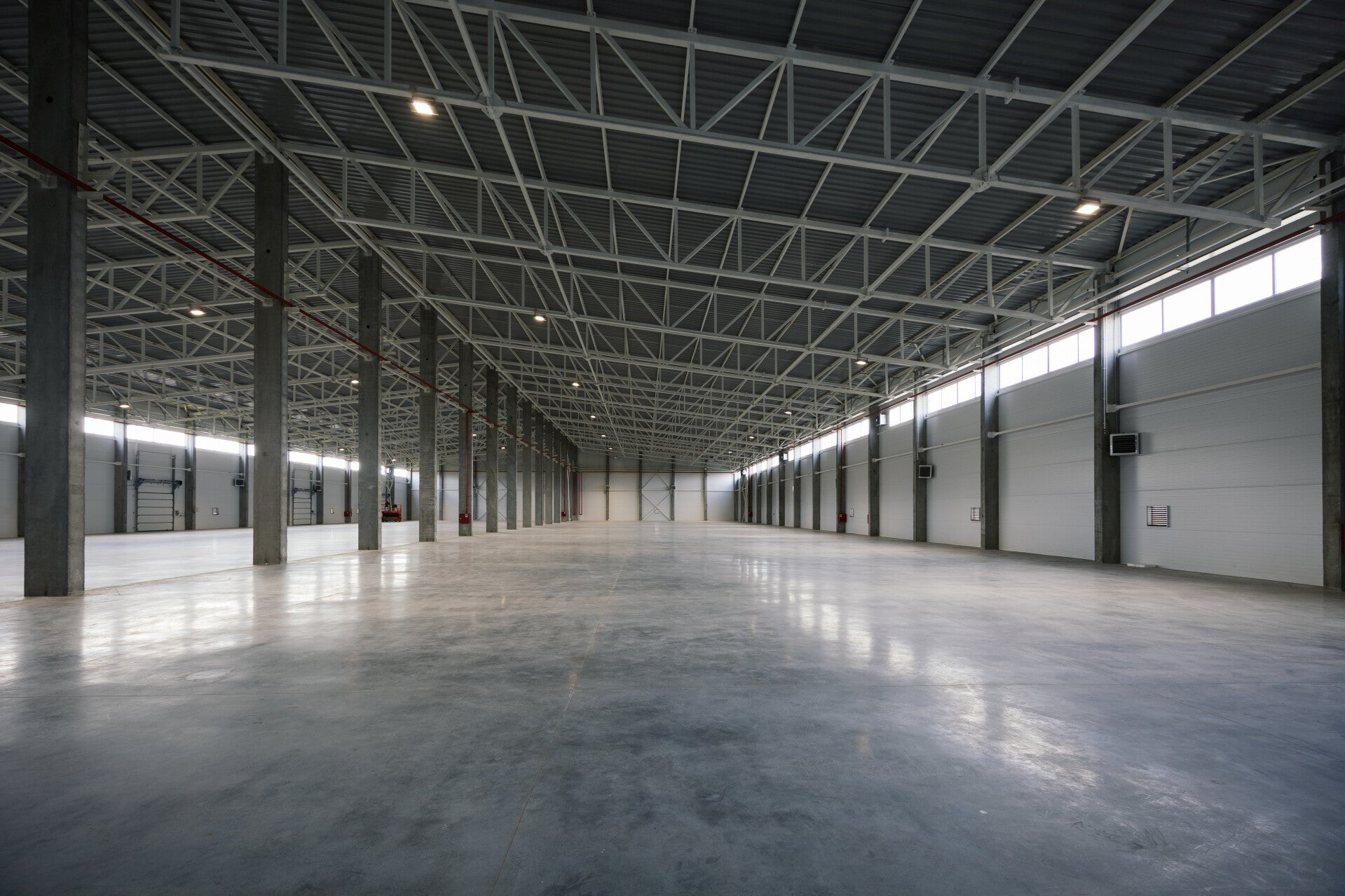 Spacious industrial warehouse interior for commercial facility maintenance and renovation services.