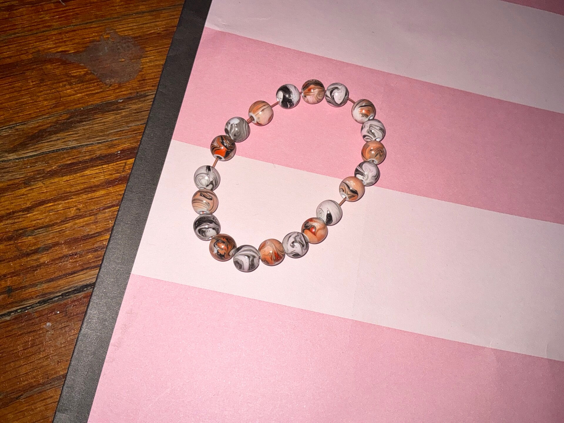 Light, orange and gray and white beaded bracelet