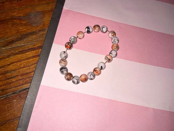Light, orange and gray and white beaded bracelet