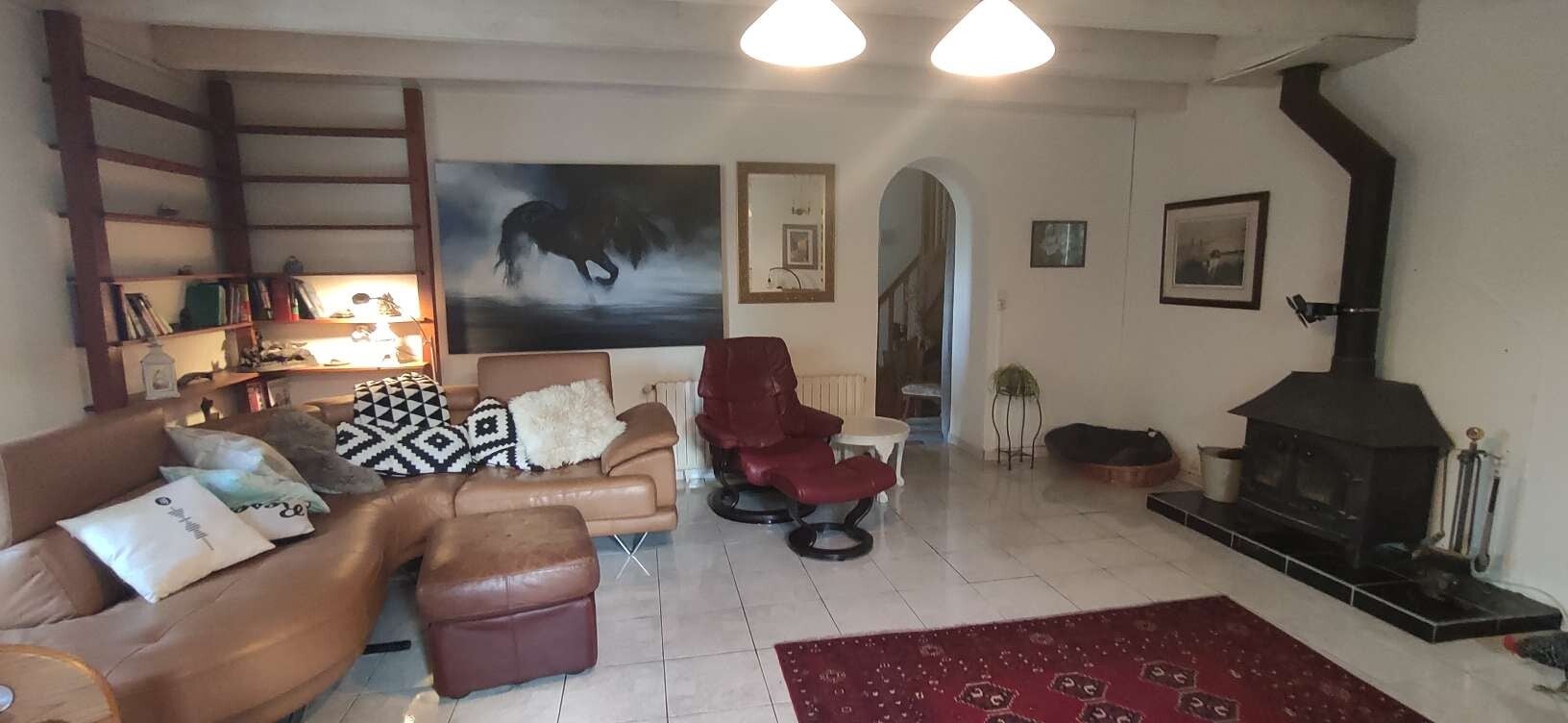 Large tiled living room with wood burning stove and also central heating