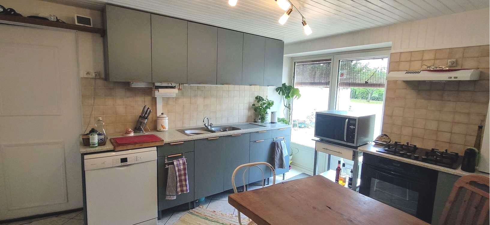 Spacious modern fitted kitchen with separate larder/ utility room