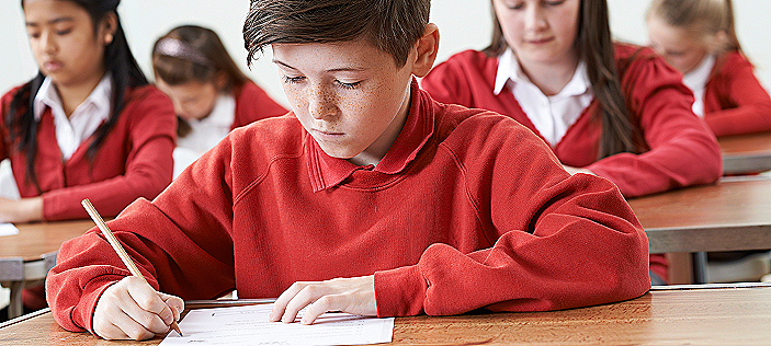 School children sitting their 11+ grammar school entrance tests under timed exam conditions.