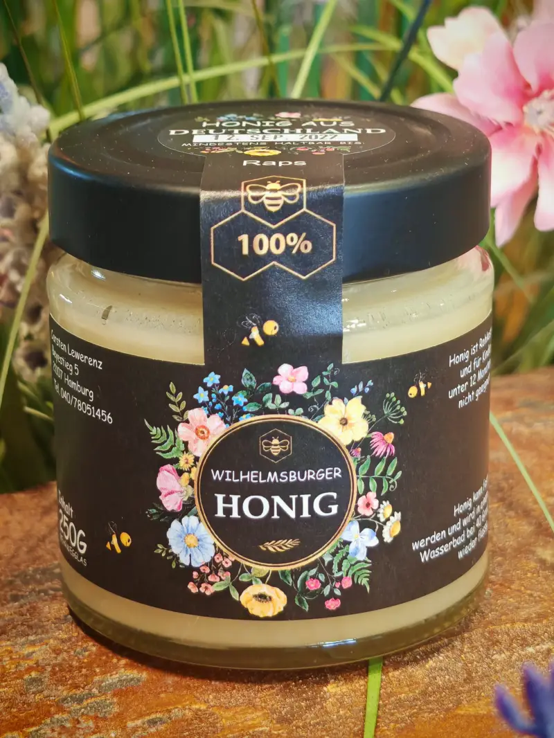 Glas Rapshonig mit schwarzem Etikett und Blumenmotiv