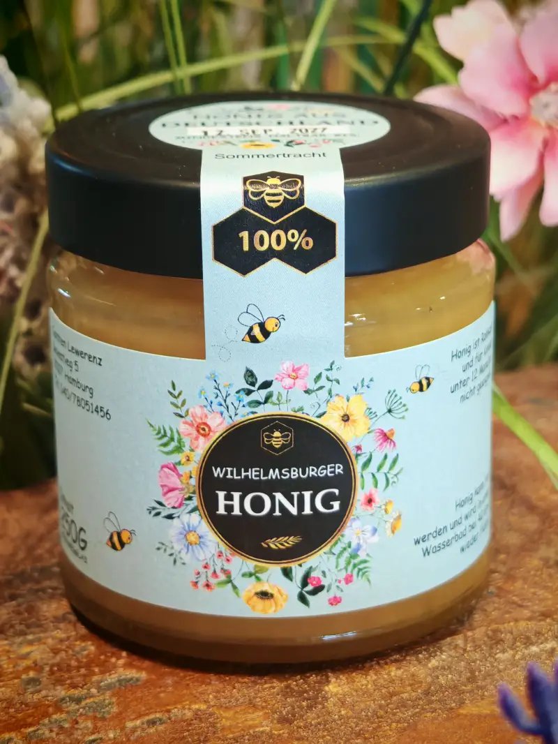 Glas Sommertrachthonigmit blauem Etikett und Blumenmotiv