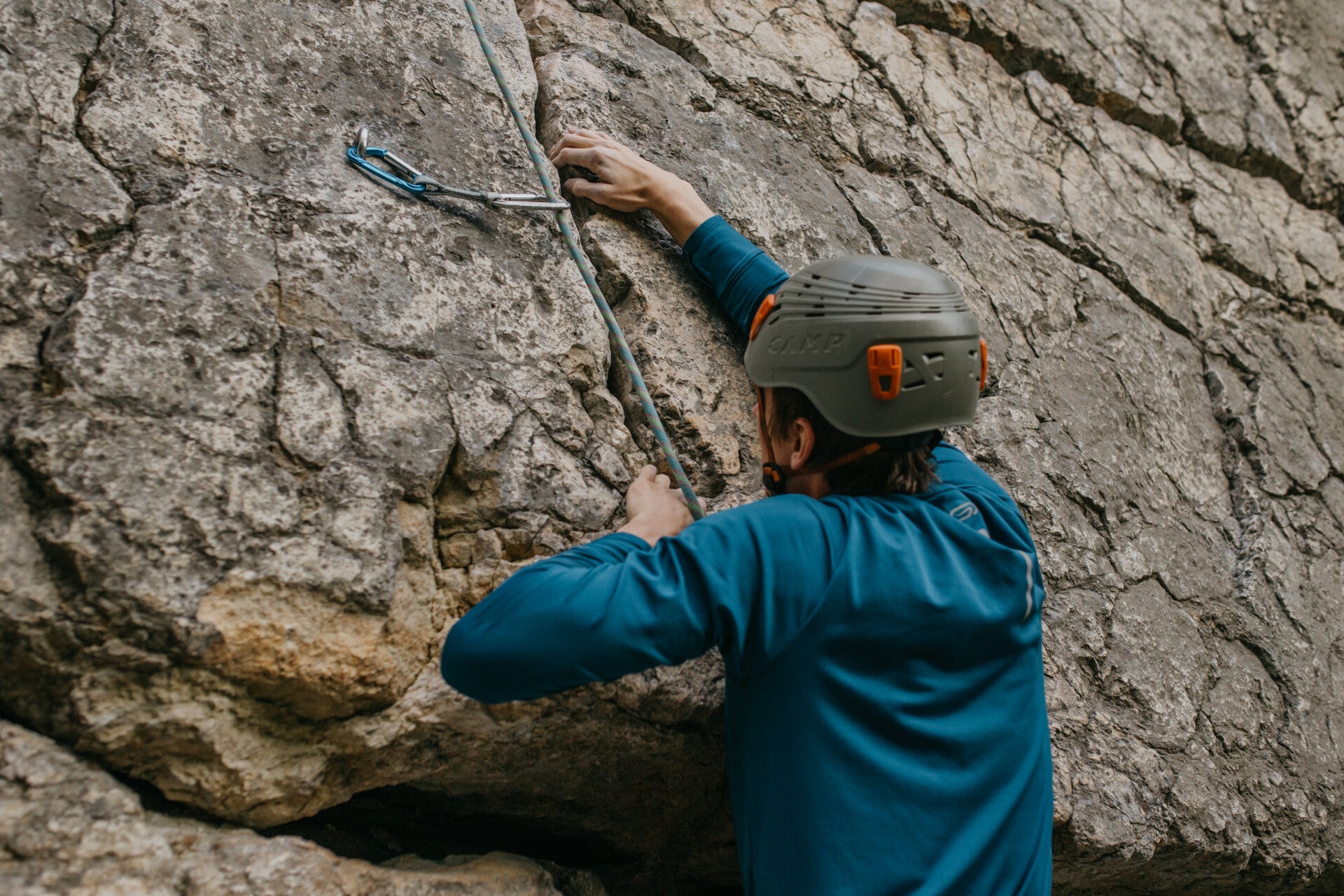 Climber climbing a rock with a top rope