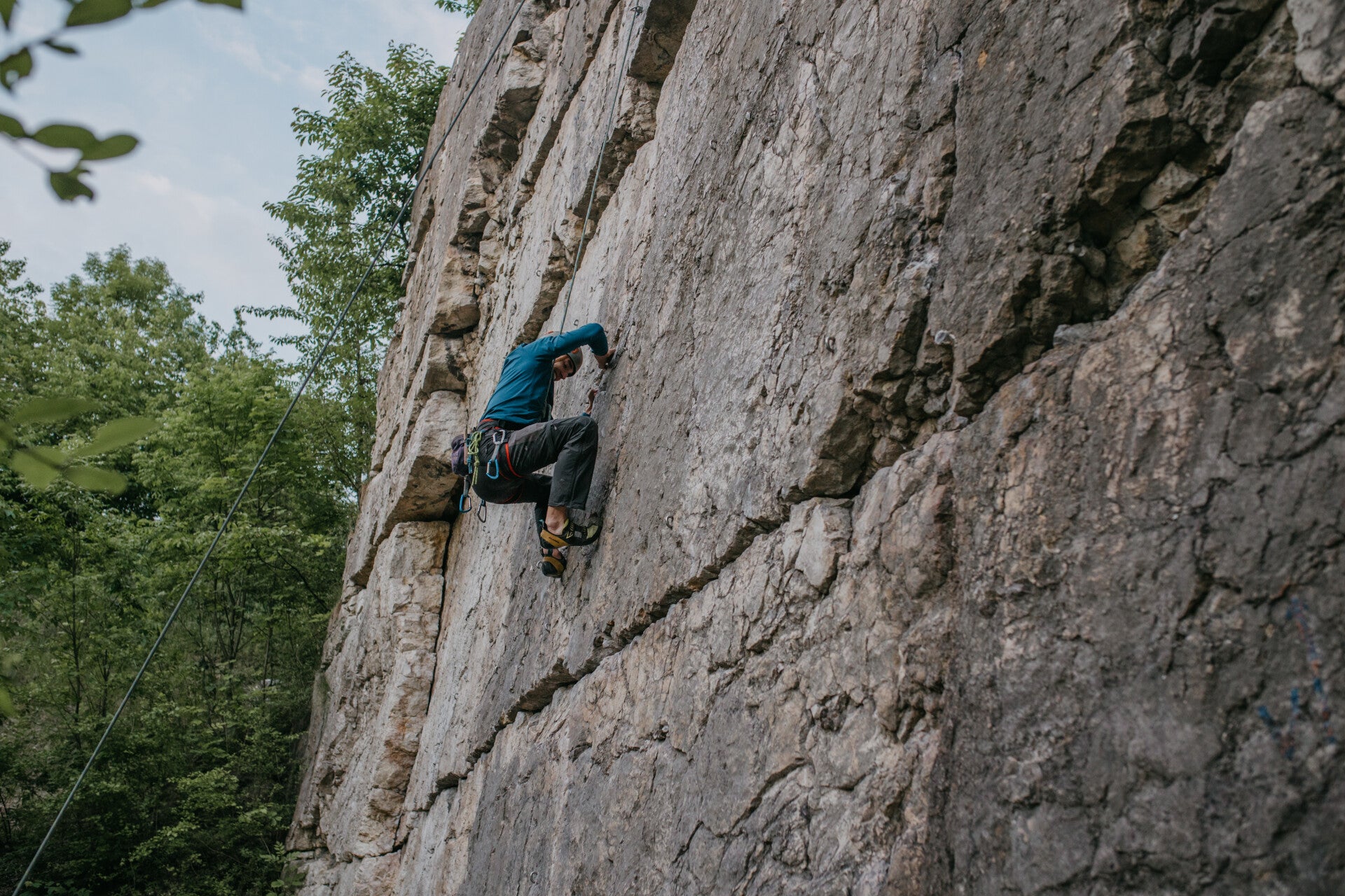 Climber climbing a rock face on a top rope