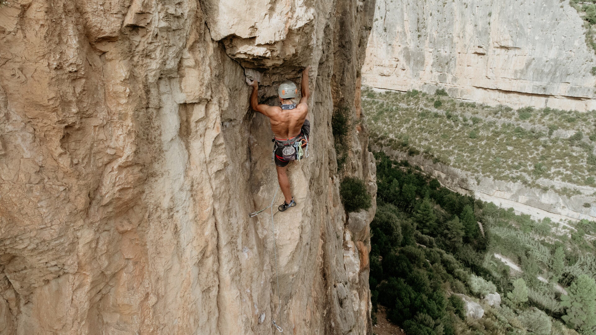Climber climbing an overhanging rock