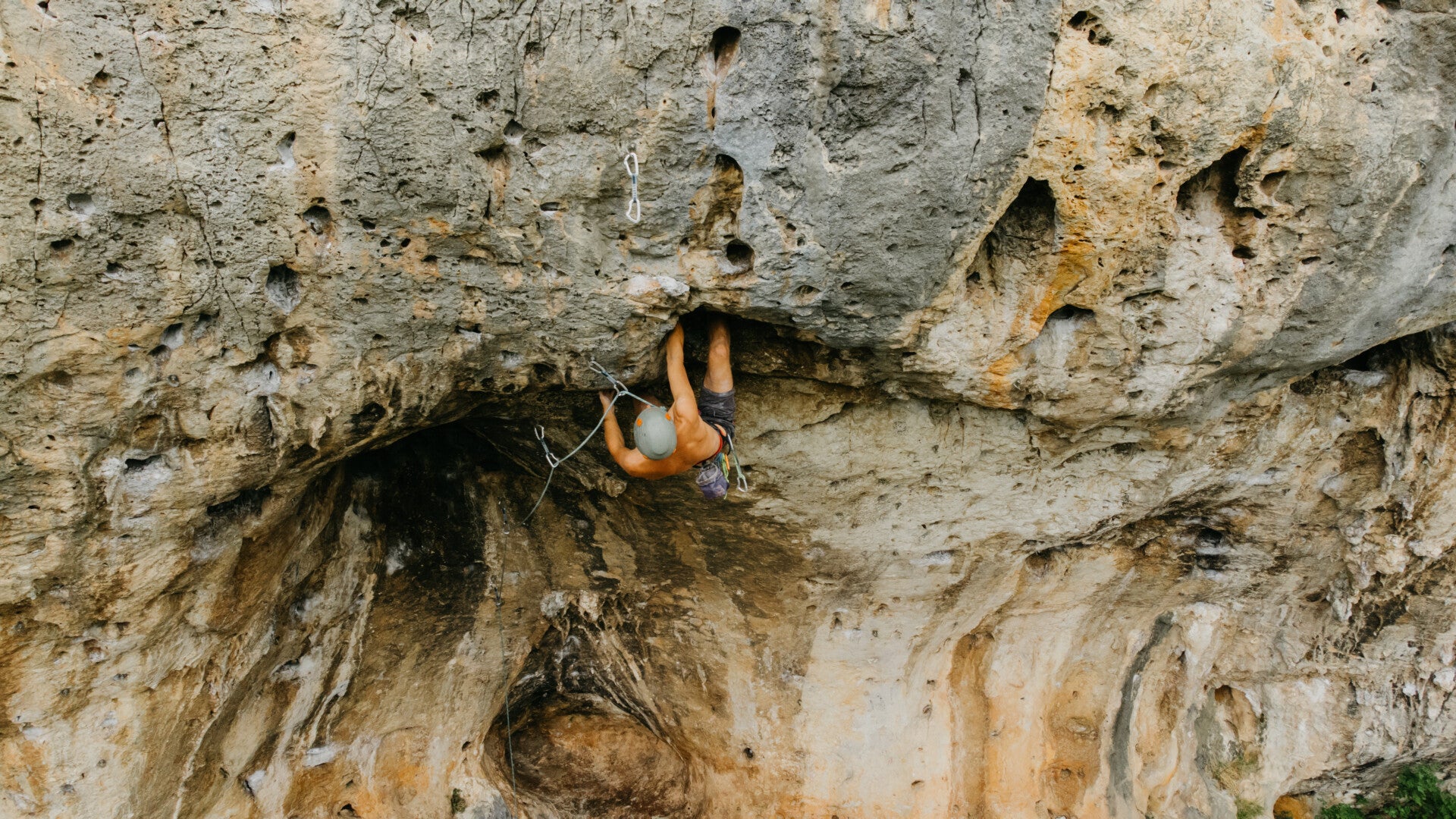 Man climbing an overhanging rock