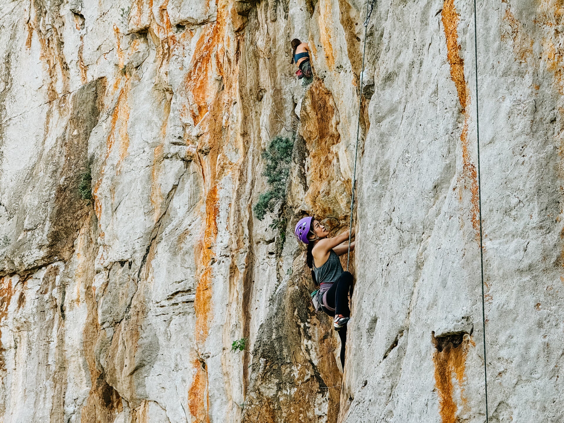 Woman climbing a rock
