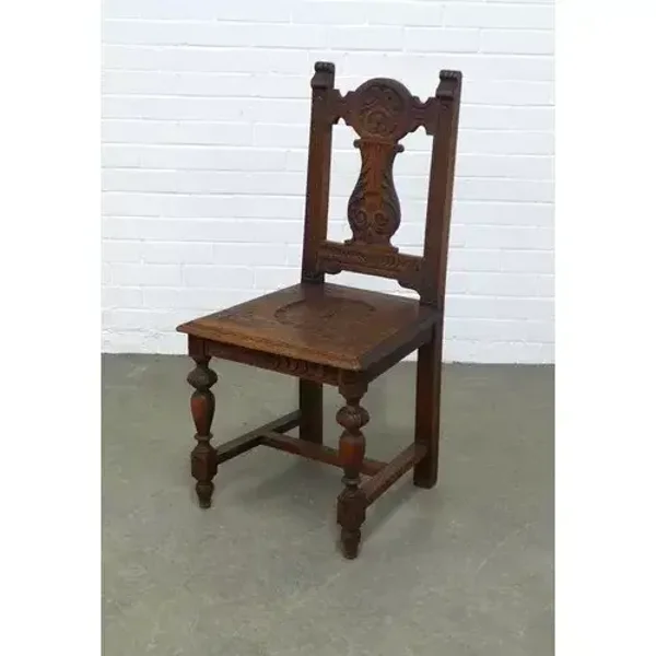 Oak hall chair with carved splat and solid seat