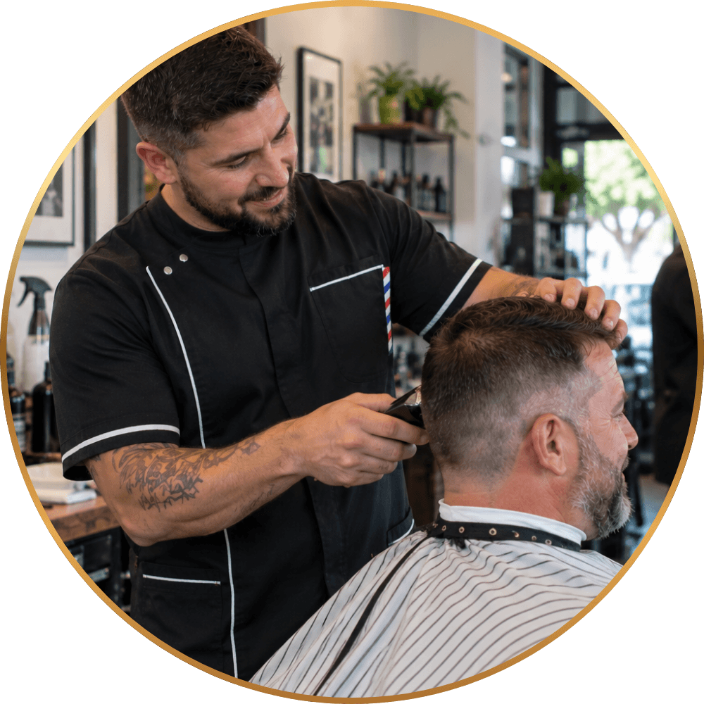 Local barber serving a customer in a neighborhood barbershop