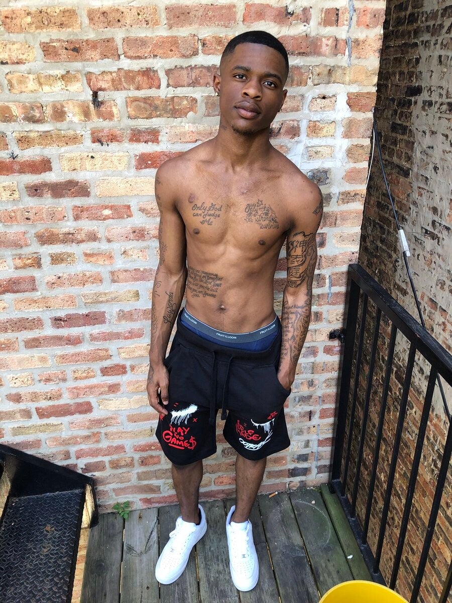 Damion Dayski posing shirtless against a brick wall when he was younger before his adult entertainment stardom.