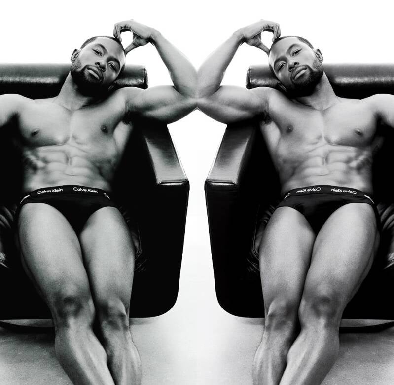 Trevante Rhodes modeling black Calvin Klein underwear, showing off fit toned body.