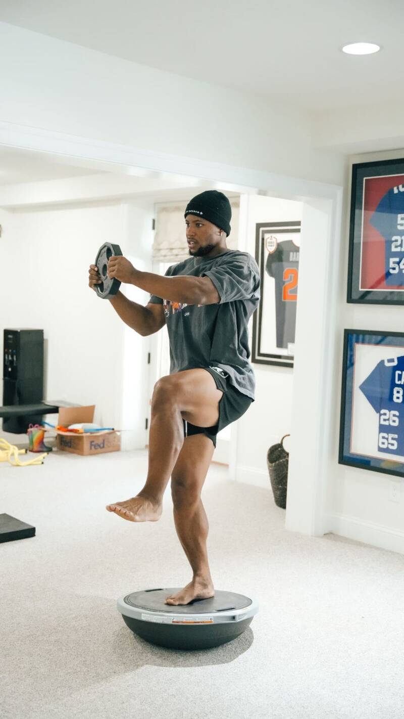 Celebrity Saquon Barkley working out at home sweaty feet out on display.