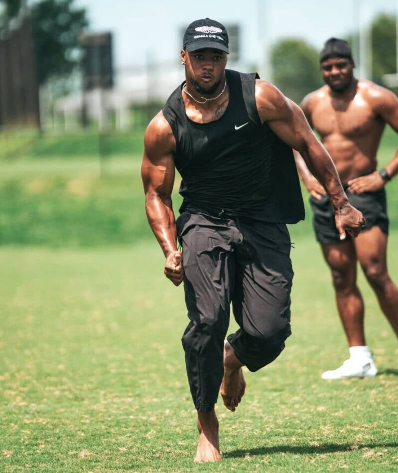 Saquon Barkley showing stamina and conditioning while working out during football practice with sweaty masculine feet on camera.