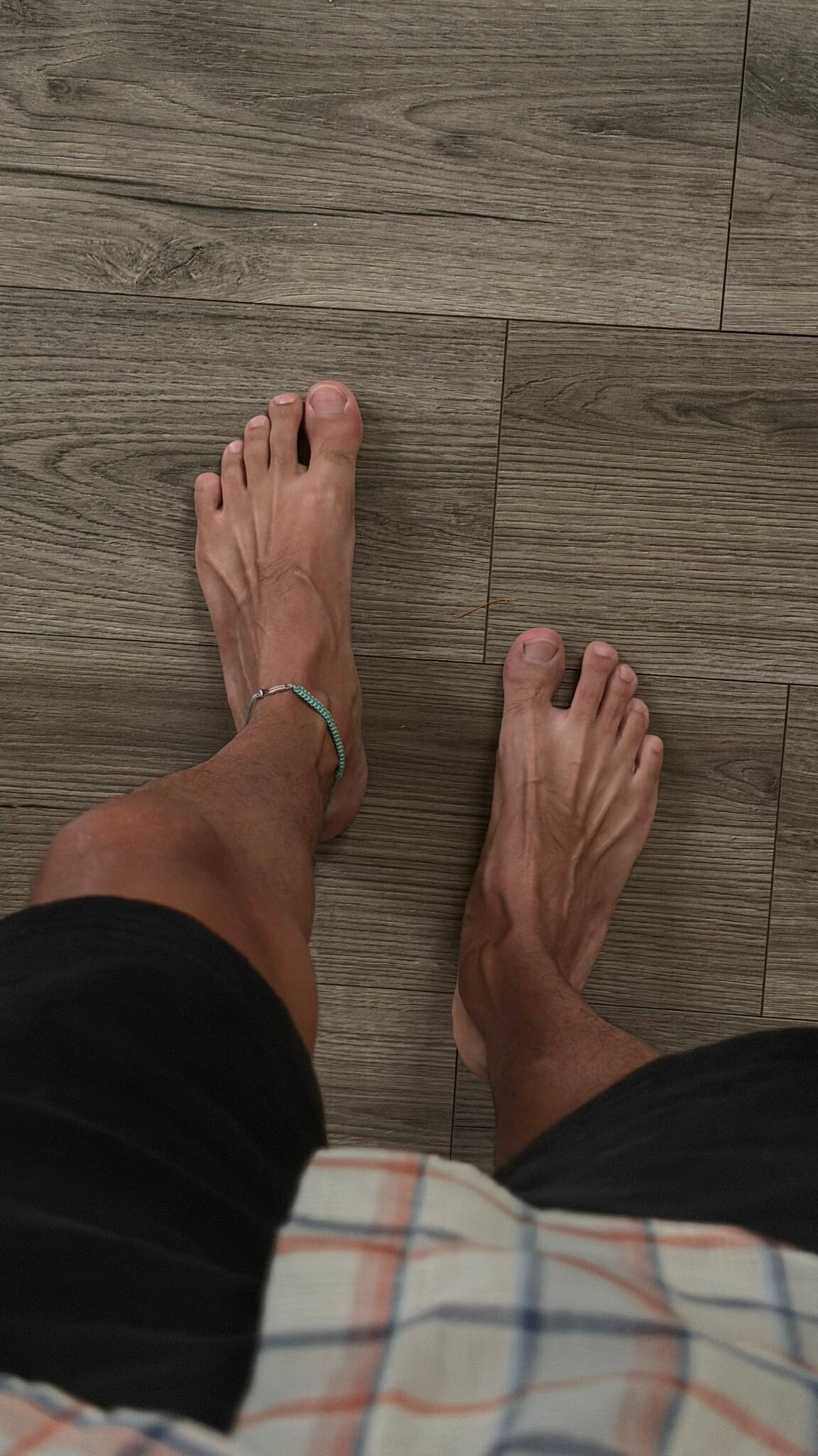 veined-masculine-light-skinned-black-mans-feet-top-view-standard.jpg