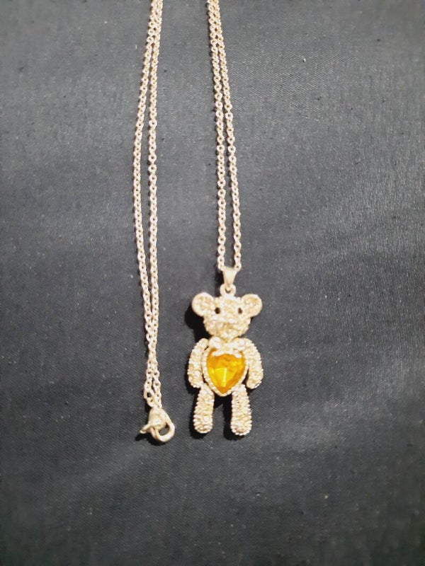 Beautiful teddybear necklace with moveable parts and an Amber coloured heart ##