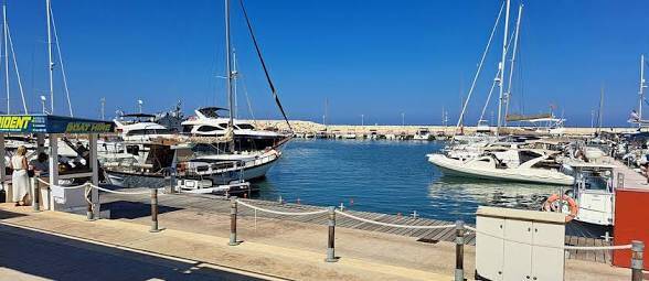 Boats moored in the calm waters of Latchi Harbour in Cyprus.