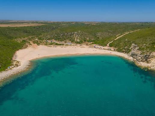 Praia do Barranco set between coastal slopes near Raposeira in the western Algarve.