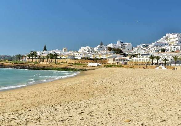 Sandy shoreline and coastal surroundings at Praia da Luz near Lagos.