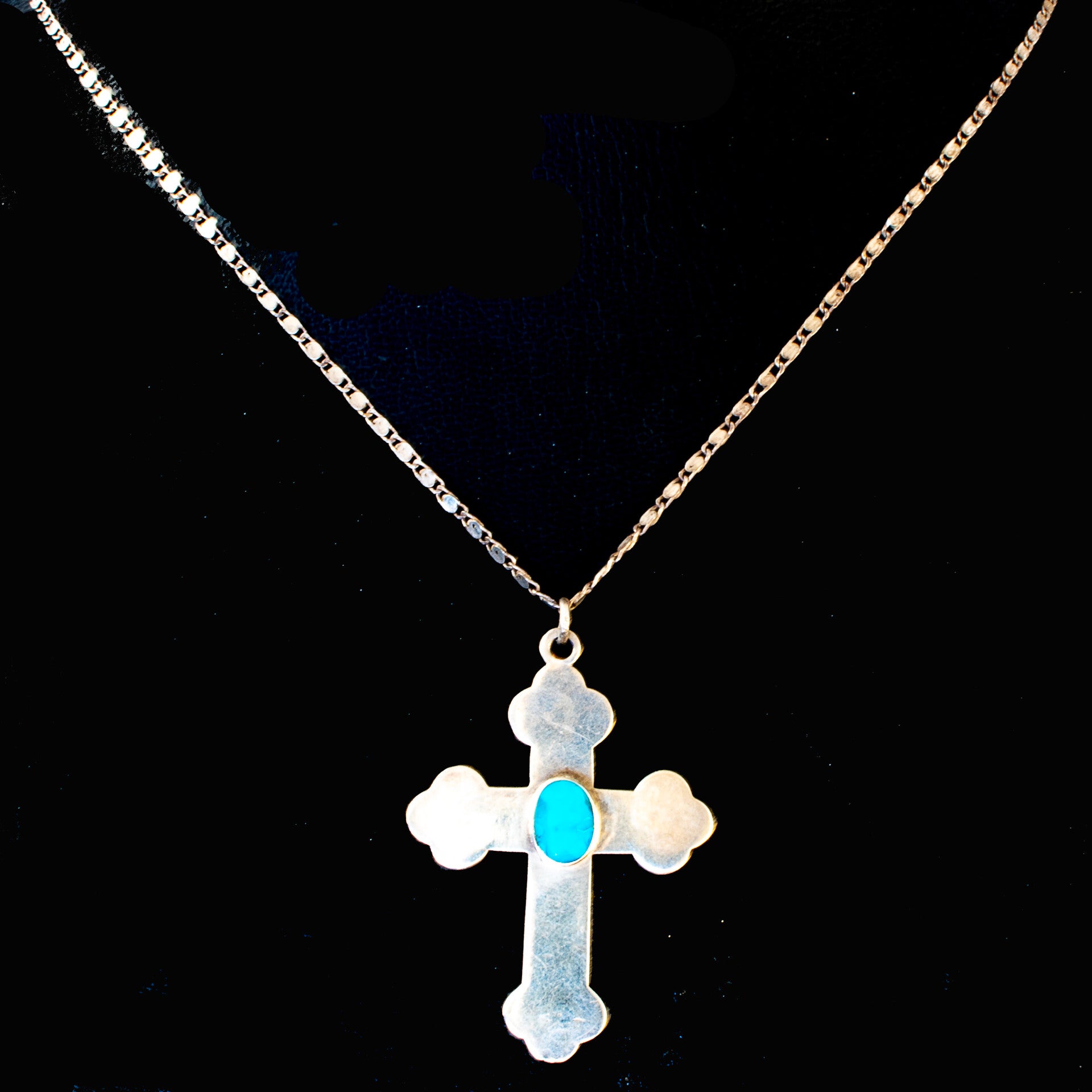 Sterling Silver "grace" cross with blue stone on the intersection of arms