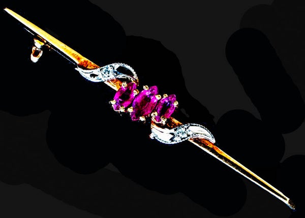 Marquise cut rubies and round diamonds on a 9 carat gold bar brooch