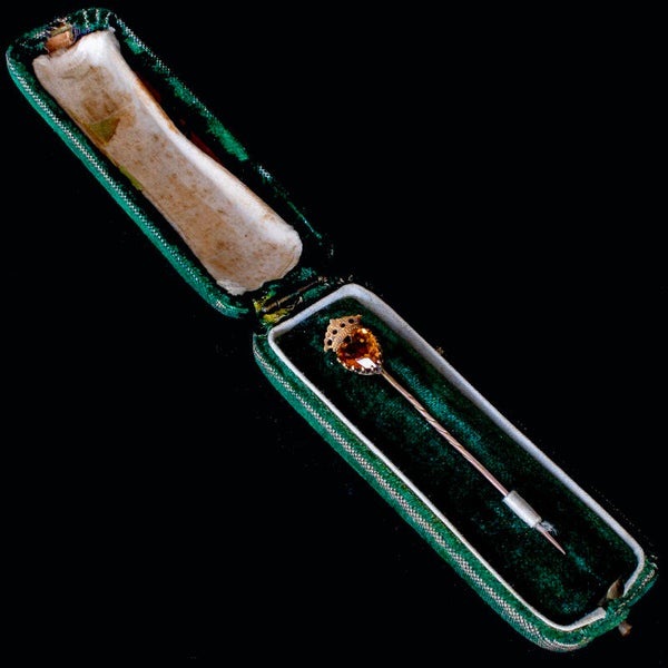 Antique cased cravat pin with heart shaped (?) Imperial Topaz stone