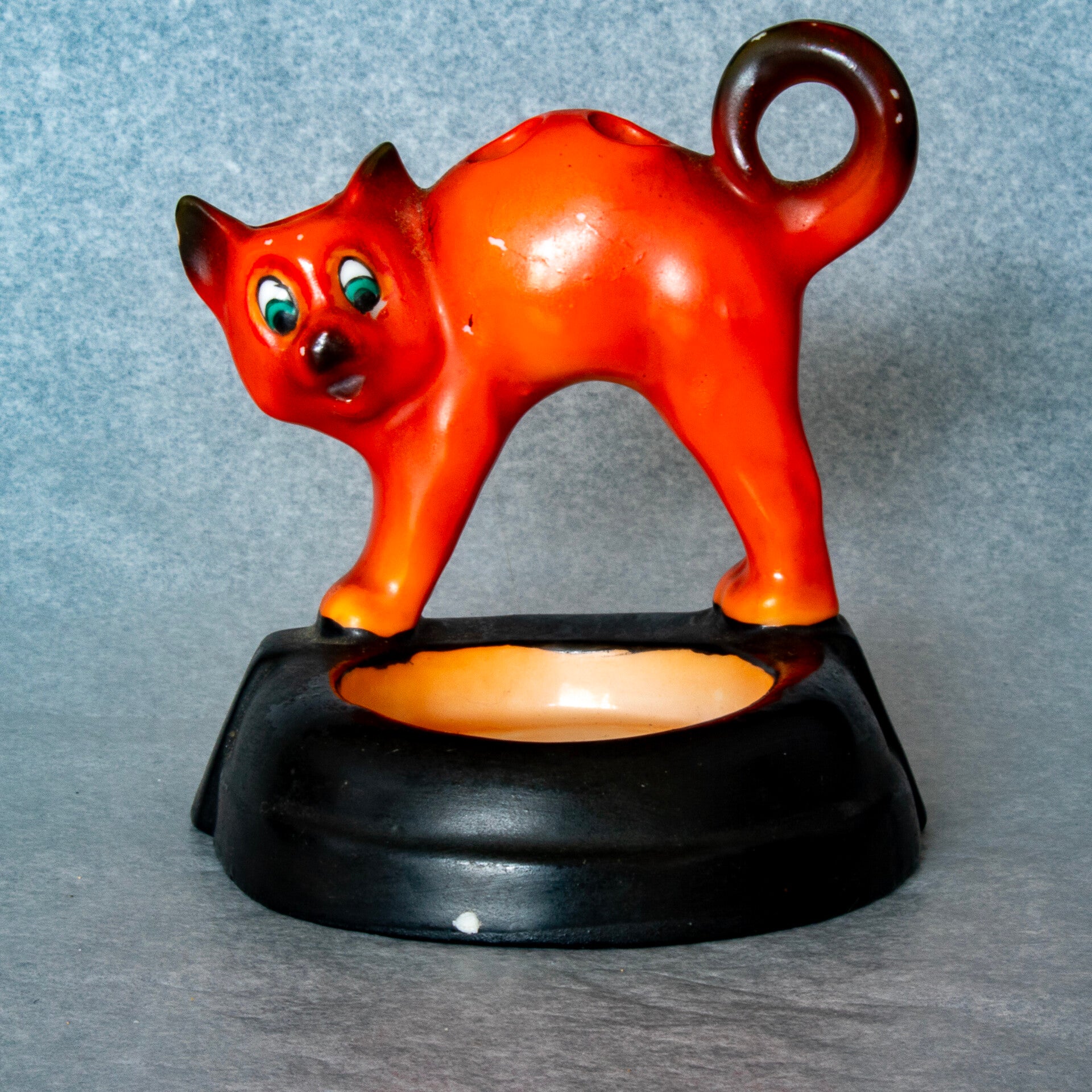 Stylish art deco cat on a toilet seat, cigarette holder and ashtray