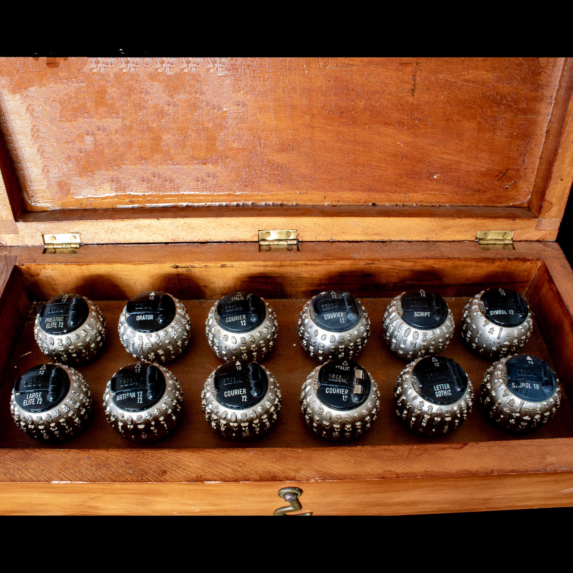 Vintage cased set of 12 IBM Selectric type elements (typeball, golfball)