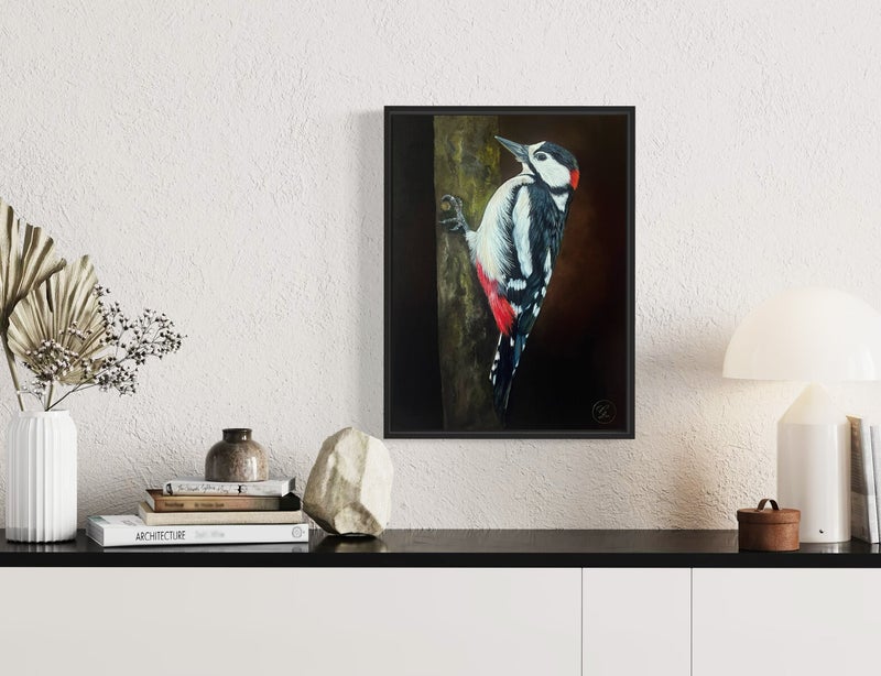 Oil painting of a great spotted woodpecker with vibrant red, black and white plumage β small bird artwork in a black float frame.