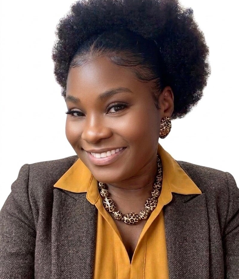 Rev. Dr. Albertina S. Dancy smiling in a gold blouse and dark jacket